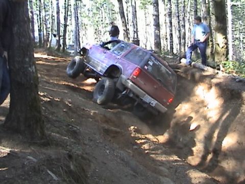 1994 Ford Explorer - SUV navigates a steep dirt incline during an off-road event.