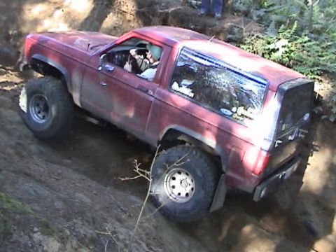 1994 Ford Explorer - Ford Bronco II navigating a steep, muddy off-road course.