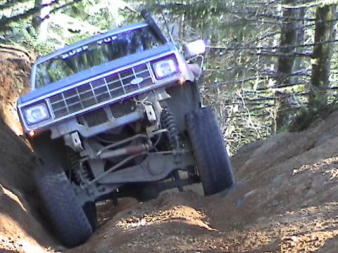 1994 Ford Explorer - This 1994 Ford Explorer navigates a challenging off-road course, demonstrating its capabilities on a steep dirt incline.