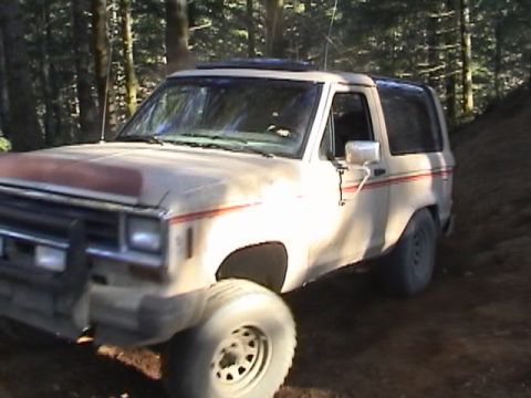 1994 Ford Explorer - A 1989 Ford Bronco II is shown off-road in a wooded area.