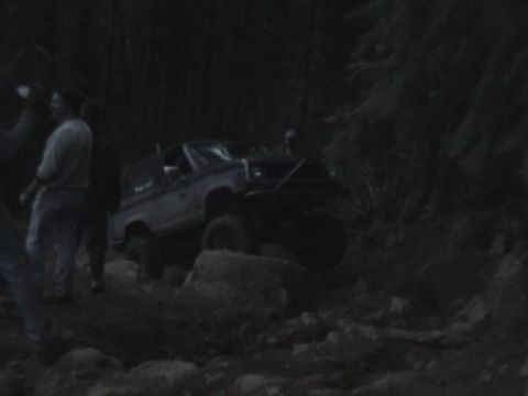 1994 Ford Explorer - An off-road vehicle is seen maneuvering over rocks on a trail.