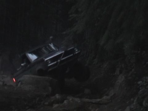 1994 Ford Explorer - Off-roading adventure captured in low light on a challenging rocky path.