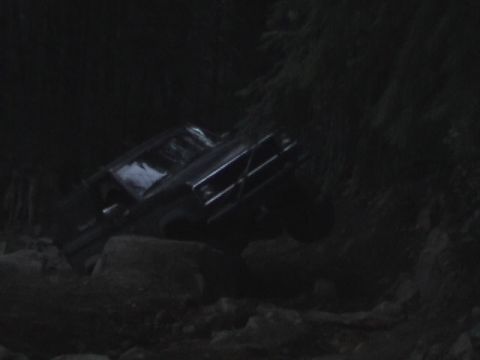 1994 Ford Explorer - An SUV is seen navigating a rocky, off-road path at night.