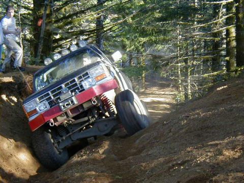 1994 Ford Explorer - A 1994 Ford Explorer navigates a steep, wooded trail during an off-road excursion.