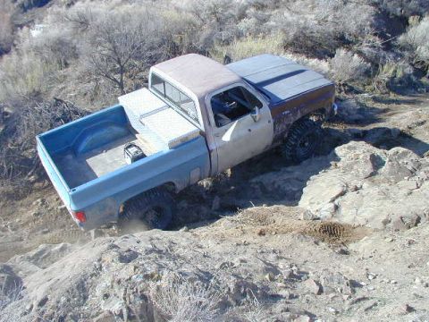 1978 Ford Bronco - Pickup truck navigates a rocky off-road trail.