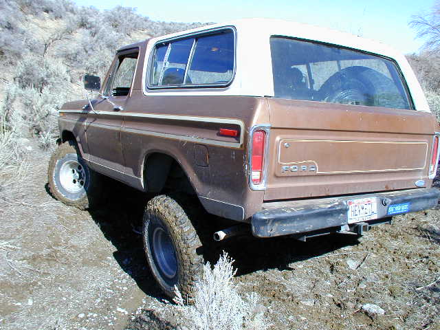 Brown 1978 Ford Bronco rear 3/4 view on dirt trail
