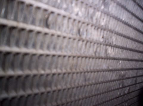 1989 Ford Bronco - Close-up view of radiator fins, showing a detailed texture of the cooling system component.