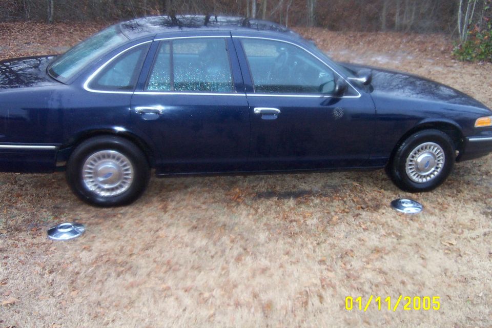 Dark blue 1997 Ford Crown Victoria sedan, side view