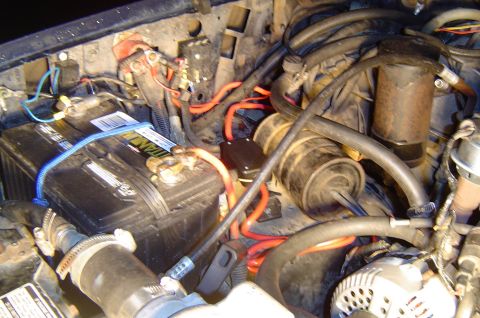 1993 Ford Bronco - Close-up view of the engine bay, showing the battery and various electrical components and wiring.