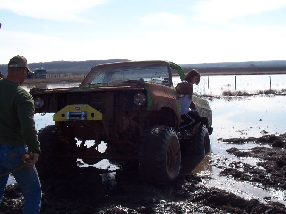 Mud bog truck stuck in water with winch on front bumper