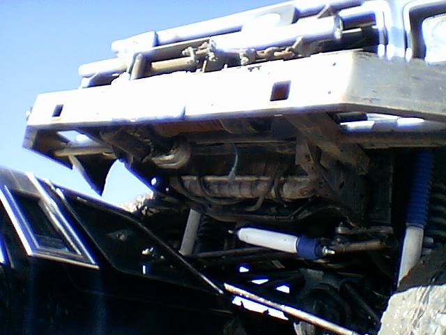 Undercarriage view of a 1979 Ford Bronco with aftermarket suspension components and a custom bumper