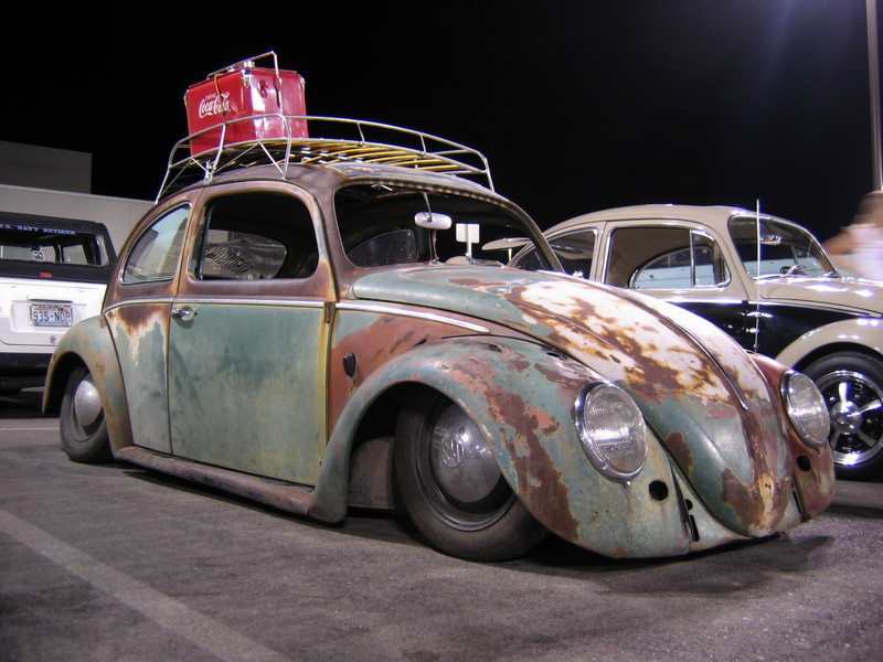 Rusty patina VW Beetle, bagged low, with roof rack and Coca-Cola cooler at night