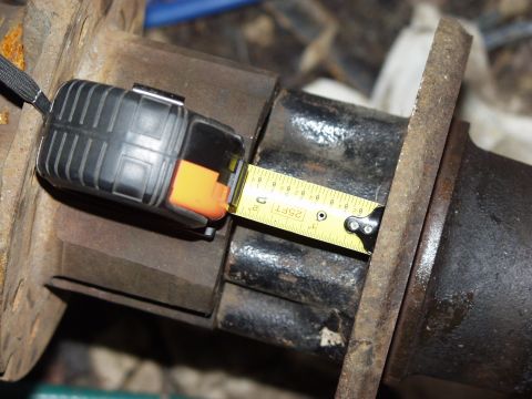 1979 Ford Bronco - A tape measure is used to check the dimensions of a vehicle's axle housing.