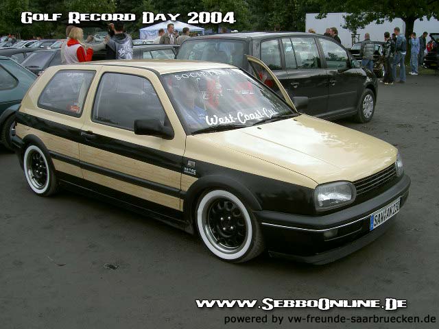 Volkswagen Golf Mk3 with wood paneling and white wall tires. Text on windshield reads 'West-Coast-Customs'