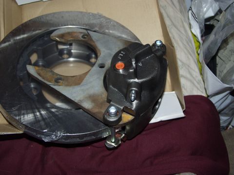 1979 Ford Bronco - New brake caliper and rotor assembly shown in its packaging.