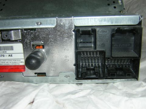 1998 Ford Crown Victoria - Rear view of a car stereo, showing various connectors and the Ford logo. Part number 1L018638 - AE is visible.