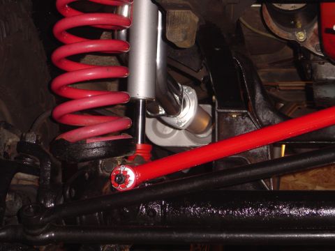 1978 Ford Bronco - Undercarriage view shows suspension parts including a red coil spring and shock absorber.