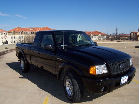 2003 Ford Ranger - A black Ford Ranger pickup truck is parked in a lot under a clear blue sky.