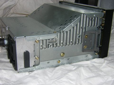 1998 Ford Crown Victoria - Rear view of a car stereo unit, showing its metal casing, heat sink, and mounting brackets.