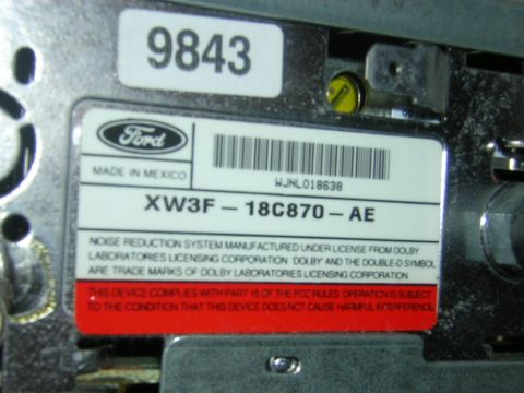 1998 Ford Crown Victoria - A label on a Ford radio shows manufacturing details and compliance information.