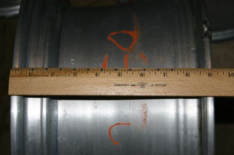 2003 Jeep TJ - A metal wheel rim is shown with a ruler for scale, marked with orange paint.