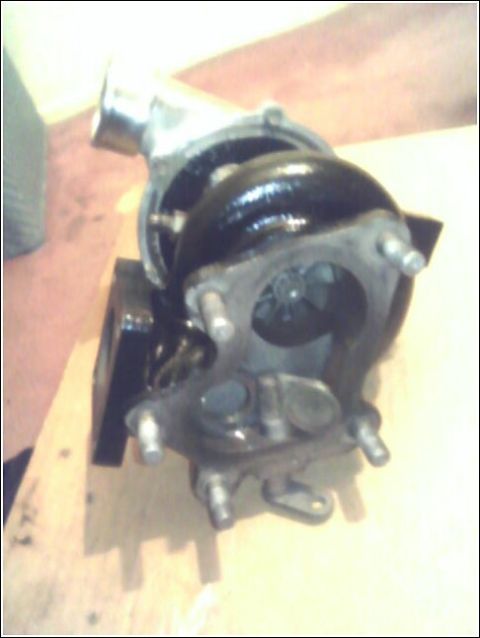 1989 Mazda MX-6 - A turbocharger part is shown, not a 1989 Mazda MX-6.