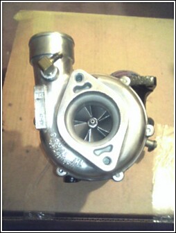 1989 Mazda MX-6 - A turbocharger is shown, with the SuperMotors logo visible at the bottom of the image.