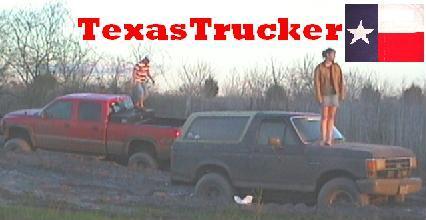 1989 Ford Bronco - Two trucks are stuck in the mud, with people standing on them.