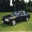 1991 Ford Mustang - A black 1991 Ford Mustang coupe is seen from the front-right quarter angle on a grassy field.