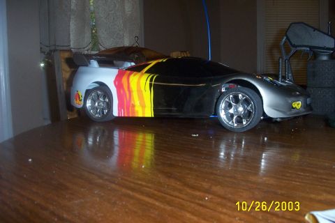 1979 Ford F-150 - A remote control car with a flame graphic design sits on a wooden table.