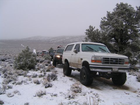 1993 Ford Bronco - Convoy of Ford Broncos driving through a snowy, desolate landscape.