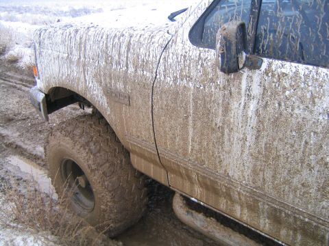 1993 Ford Bronco - Muddy 1993 Ford Bronco stuck in off-road conditions.