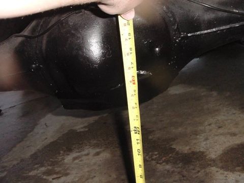 1971 Ford Bronco - A yellow measuring tape is shown against a black rear differential, indicating its dimensions.