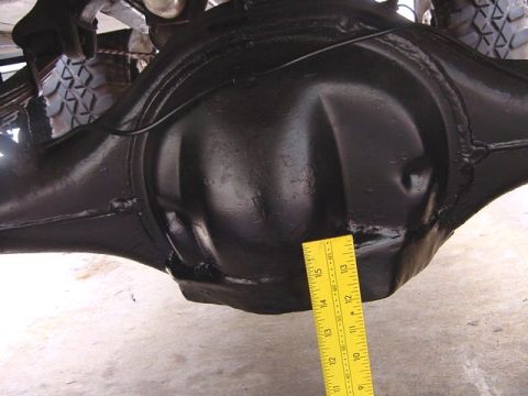 1971 Ford Bronco - A yellow ruler is placed against a vehicle's rear differential housing.