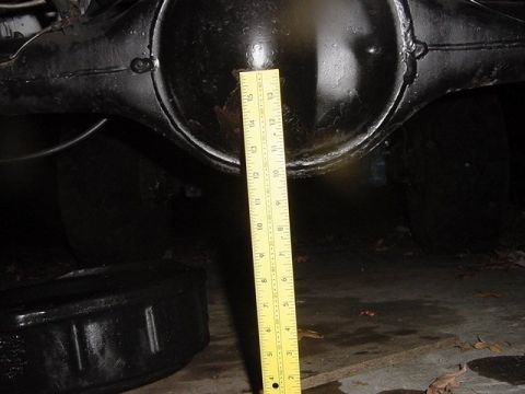 1971 Ford Bronco - A ruler is placed against the rear differential of a vehicle.
