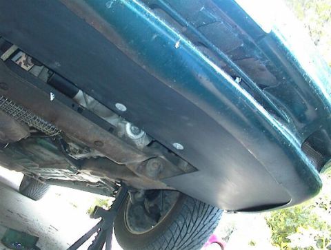 1993 Ford Taurus - The underside of a vehicle is shown, with various mechanical parts visible.
