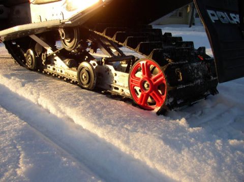 2003 Polaris 600 PRO X - Close-up of the track and suspension system on a 2003 Polaris 600 PRO X snowmobile.