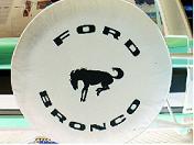 1995 Ford Bronco - A spare tire cover displays the Ford Bronco name and logo.