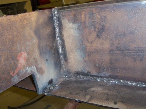 1989 Ford Bronco - Close-up of a welded metal frame, showing signs of rust and welding heat.