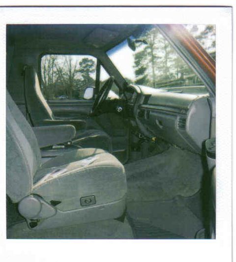 1995 Ford Bronco - The interior of a truck is visible, with a focus on the seats and dashboard.