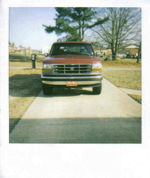 1995 Ford Bronco - Front view of a red 1995 Ford Bronco parked on a driveway.