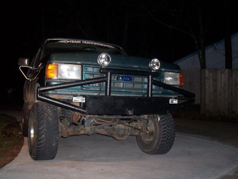1989 Ford Bronco - Front view of a 1989 Ford Bronco equipped with an aftermarket brush guard and auxiliary lights.