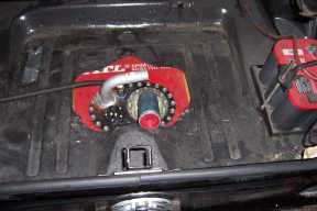 1971 Ford Mustang - A red fuel cell and two batteries are visible in the trunk of a vehicle.