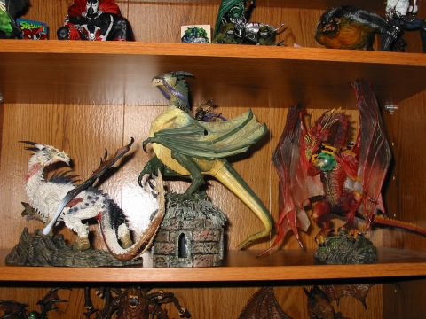 1991 Ford Bronco - A collection of fantasy dragon figurines are displayed on a wooden shelf.