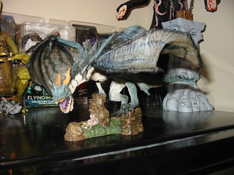 1991 Ford Bronco - A dragon figurine is displayed on a shelf with other collectibles.