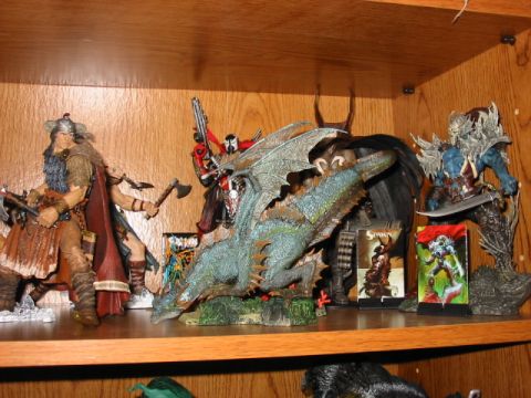 1991 Ford Bronco - Shelf display features various fantasy action figures and a dragon statue, with comic book-style packaging visible.