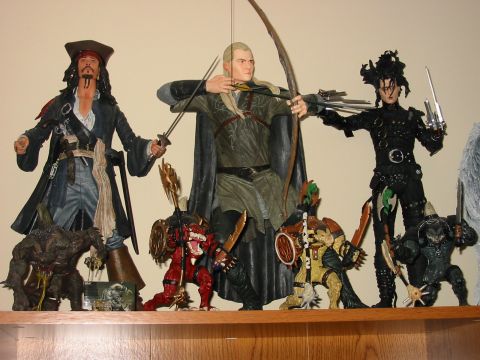 1991 Ford Bronco - A collection of movie character action figures are displayed on a shelf.
