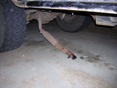 1995 Ford Bronco - The exhaust system appears to be damaged and is hanging precariously low.