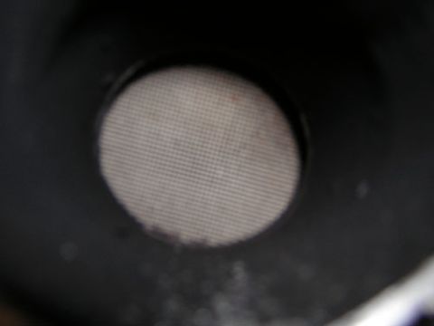 1995 Ford Bronco - A close-up view of a vehicle's exhaust pipe screen, showing its fine mesh construction.