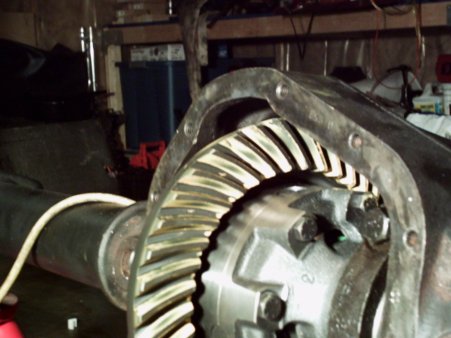 1986 Ford Bronco - Close-up view of differential gears within a metal housing, with a white cable visible.